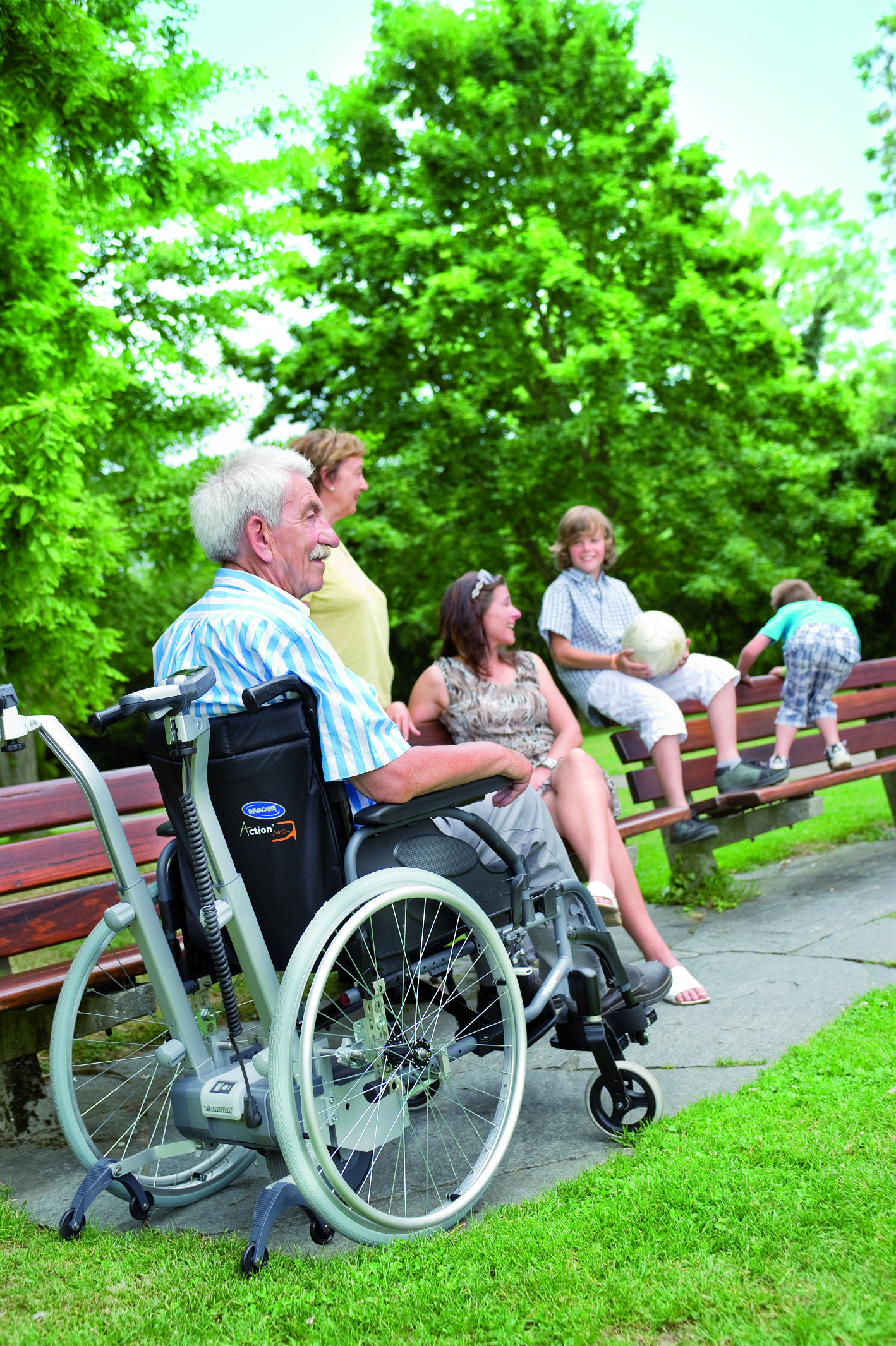 A male wheelchair user socialises with friends outside